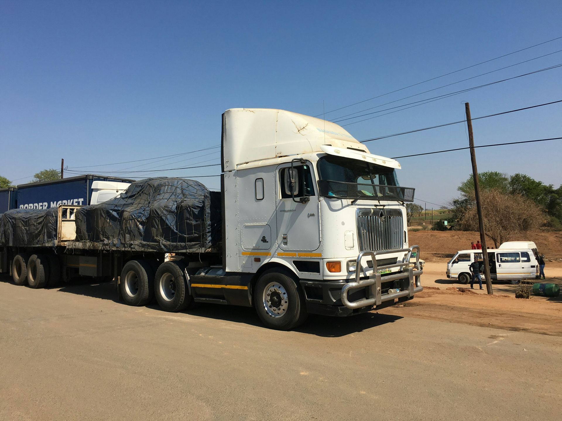 a semi truck with a trailer is parked on the side of the road